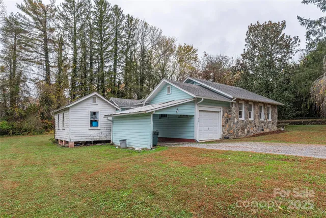 a white house that has a tree in front of it