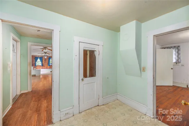 hallway with wooden floor and a livingroom