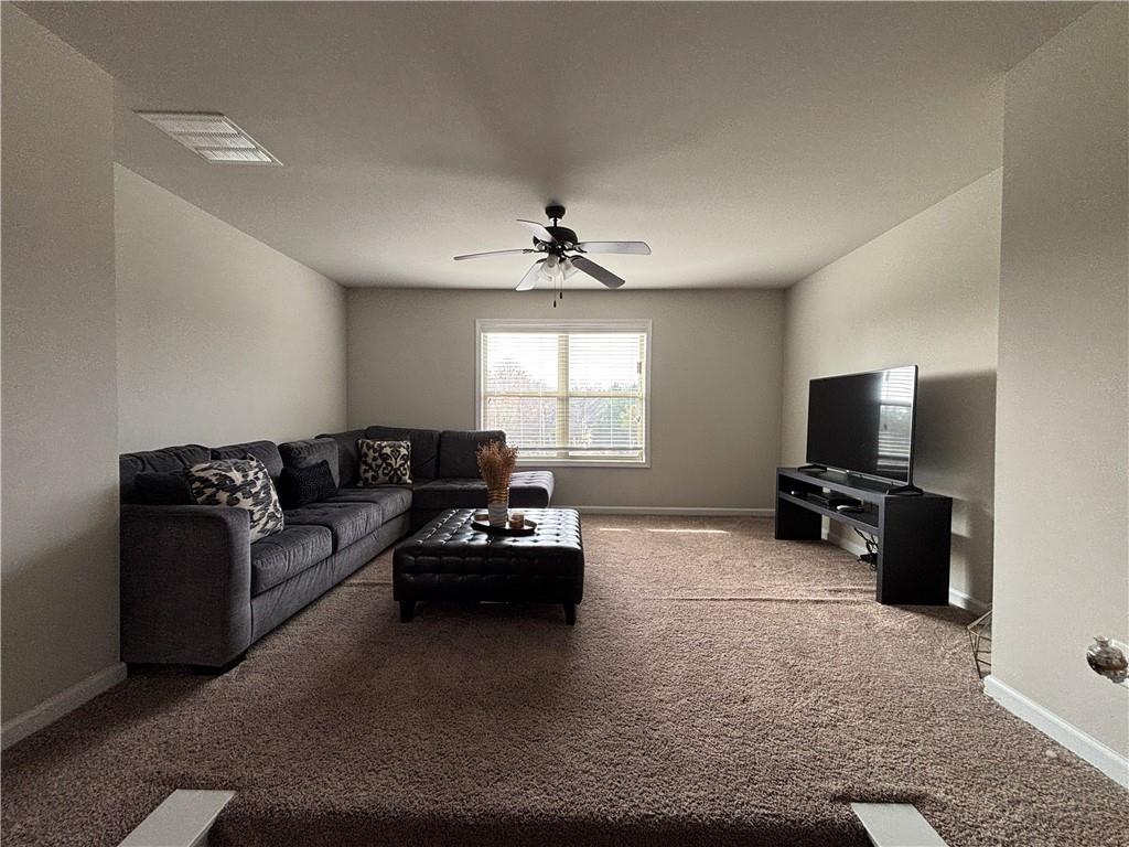 3459 In Bloom Way Auburn, GA 30011 - Photo 17 of 35 a living room with furniture and a flat screen tv