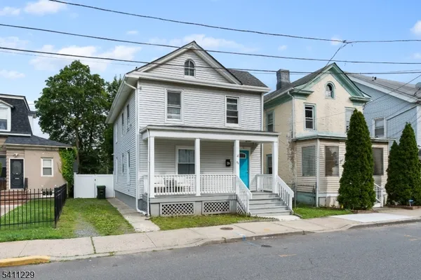 a front view of a house with a garden and plants