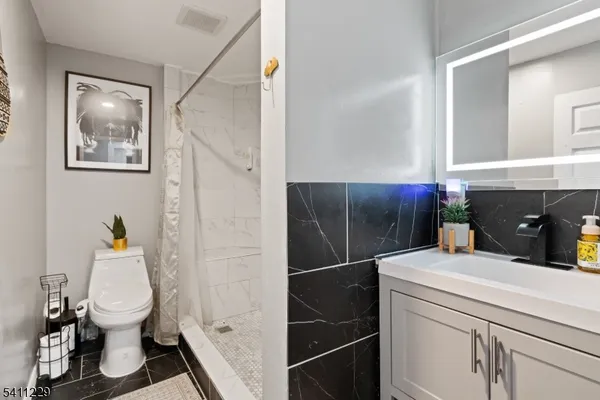 a bathroom with a sink toilet and shower