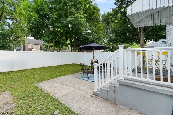 a view of a deck with a table and chair under an umbrella
