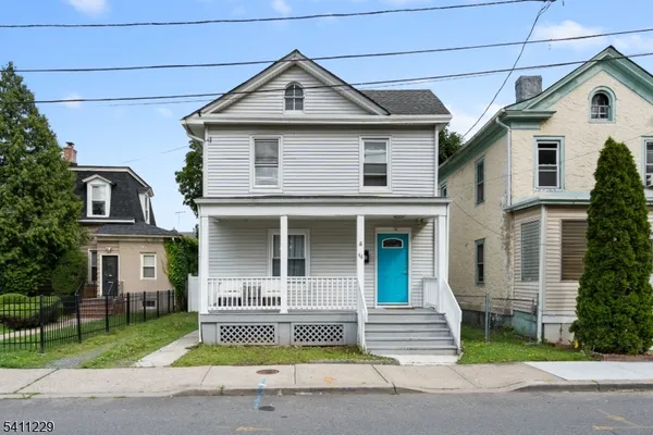 a front view of a house with a garden and plants
