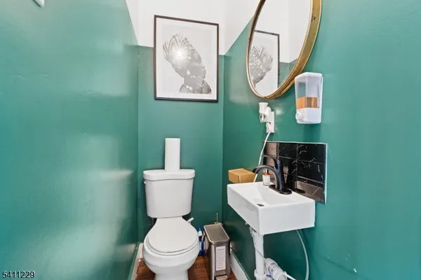 a bathroom with a toilet a sink and mirror