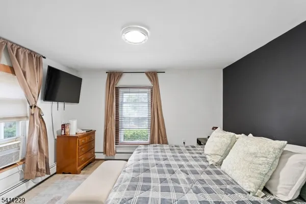 a bedroom with a bed and flat screen tv