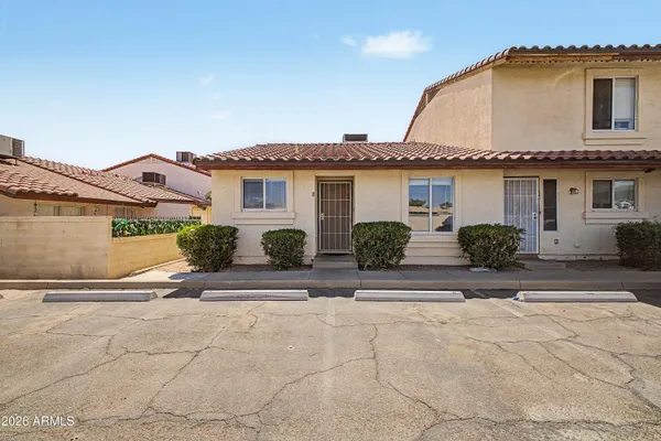 a view of a house with a yard and plants