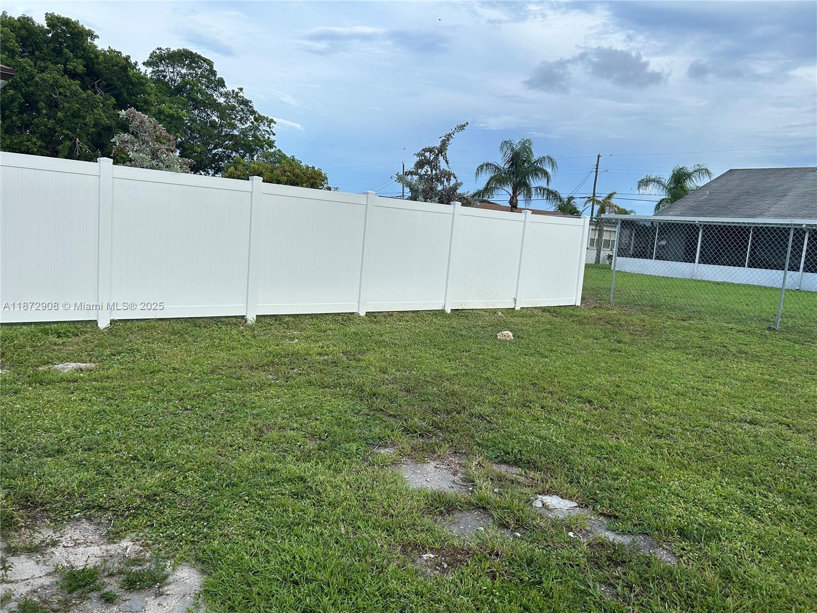 4340 Southwest 24th Street, Unit 1 West Park, FL 33023 - Photo 6 of 6 a view of a big yard with potted plants