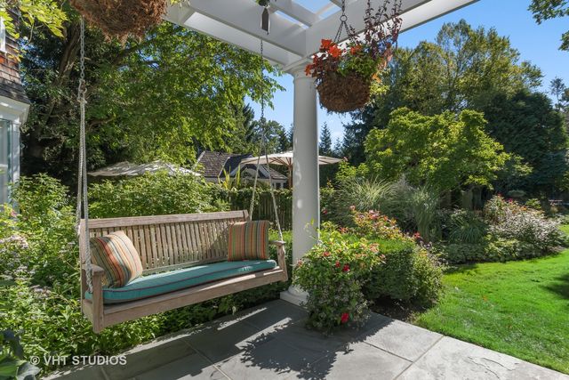 a view of a house with backyard and sitting area