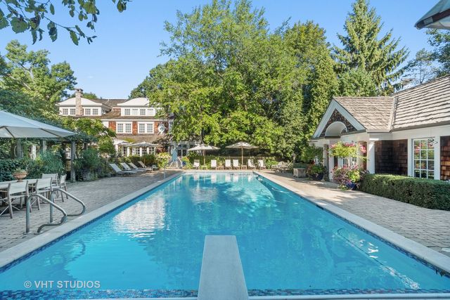 a front view of a house with a fountain