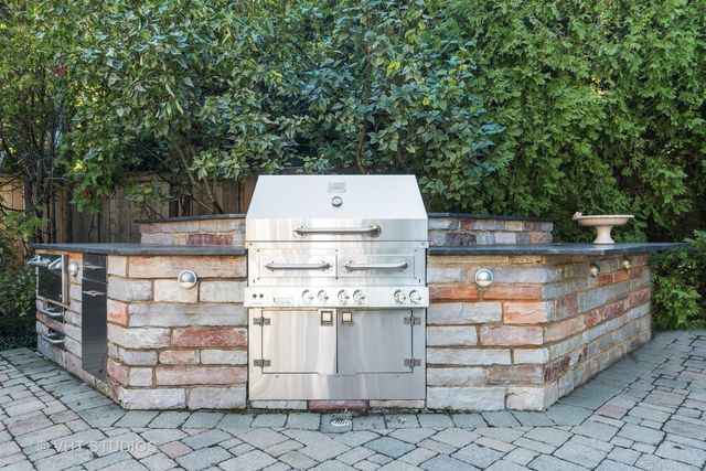 a front view of a house with a yard and lake view