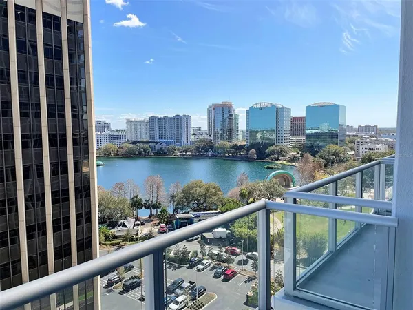 a view of a balcony with city and lake view