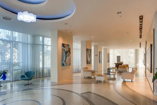 a large white kitchen with a large window