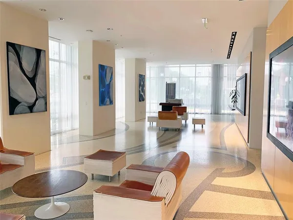 a living room with furniture a flat screen tv and a large window