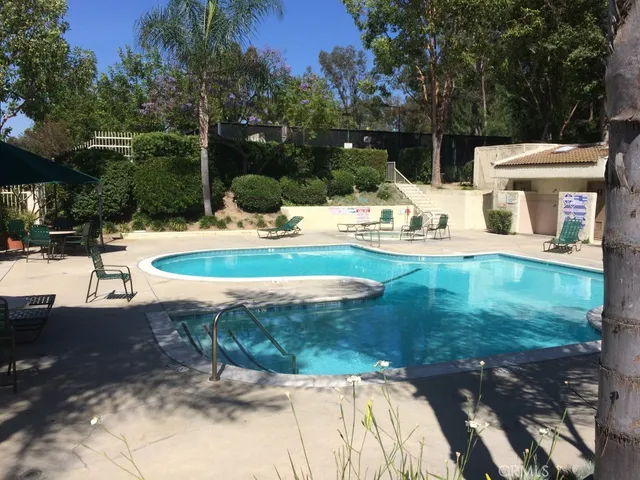 a swimming pool with outdoor seating and yard
