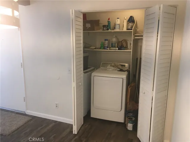 a view of washer and dryer with kitchen in the background