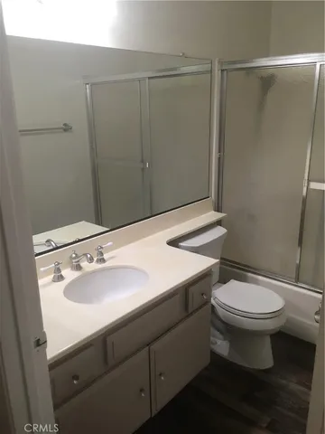 a bathroom with a sink a toilet a mirror and vanity