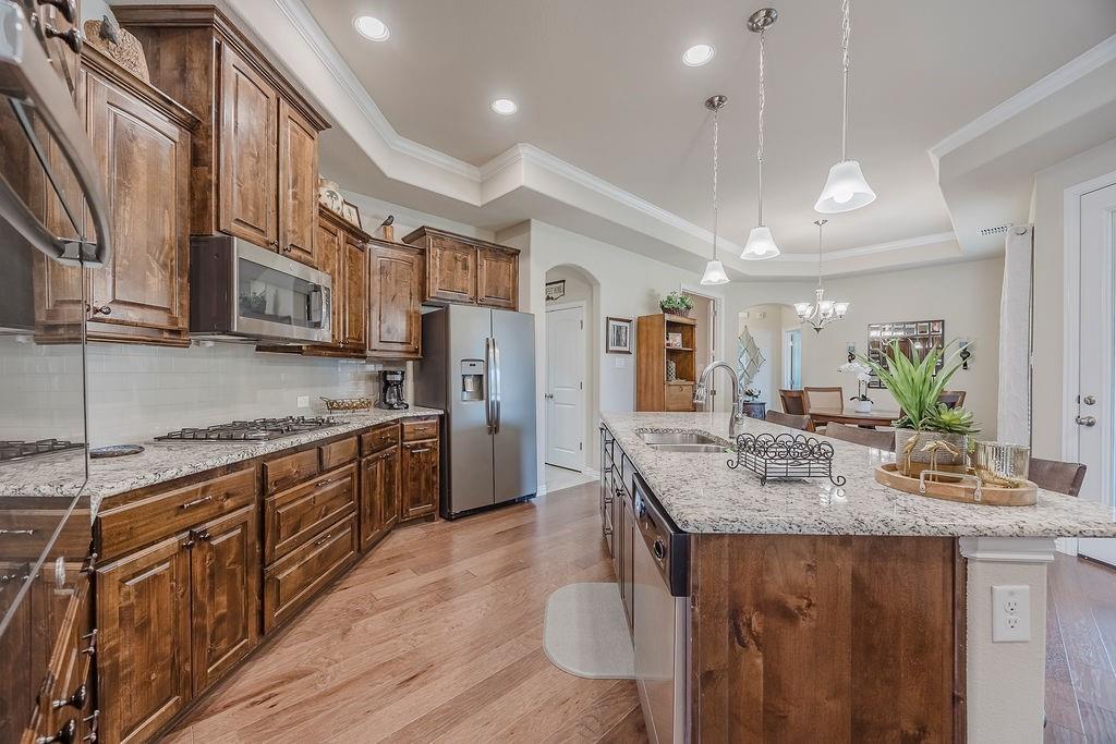 2123 Ladera Way, Unit 2123 Mansfield, TX 76063 - Photo 14 of 34 a kitchen with stainless steel appliances granite countertop a sink refrigerator and cabinets