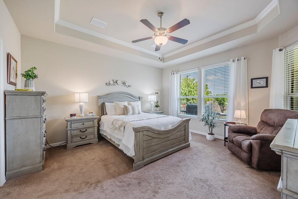 2123 Ladera Way, Unit 2123 Mansfield, TX 76063 - Photo 20 of 34 a bedroom with a large bed couch and windows