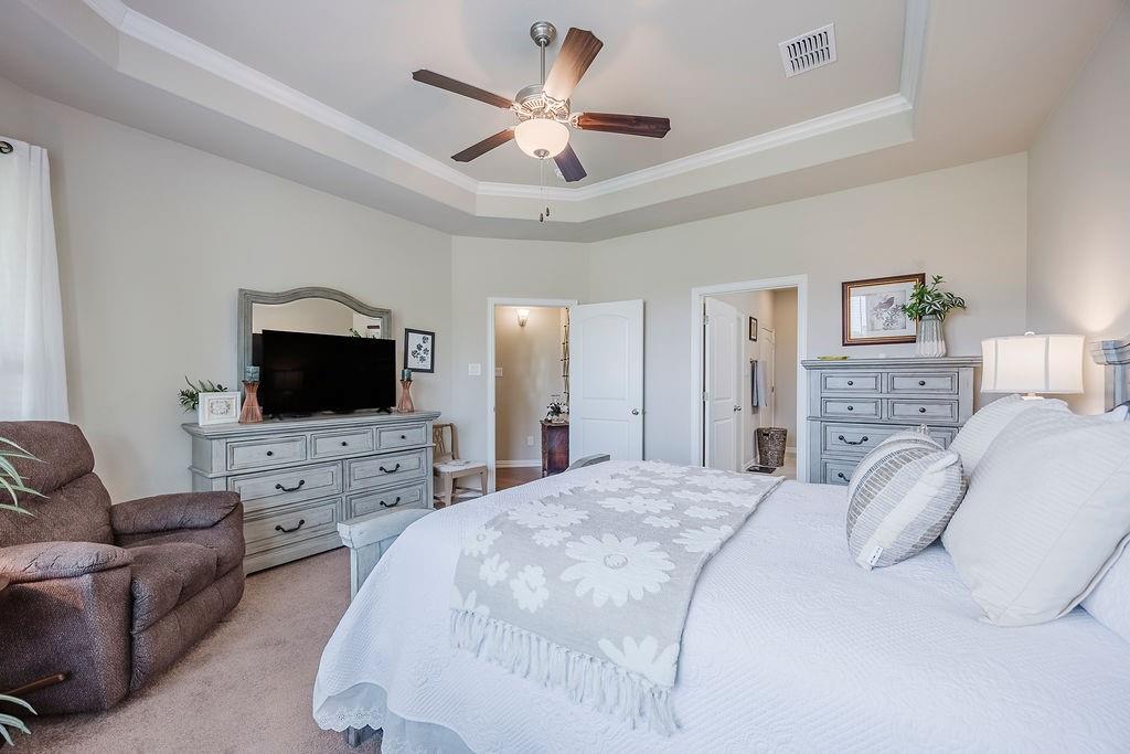 2123 Ladera Way, Unit 2123 Mansfield, TX 76063 - Photo 26 of 34 a bedroom with a bed a flat screen tv and a couch