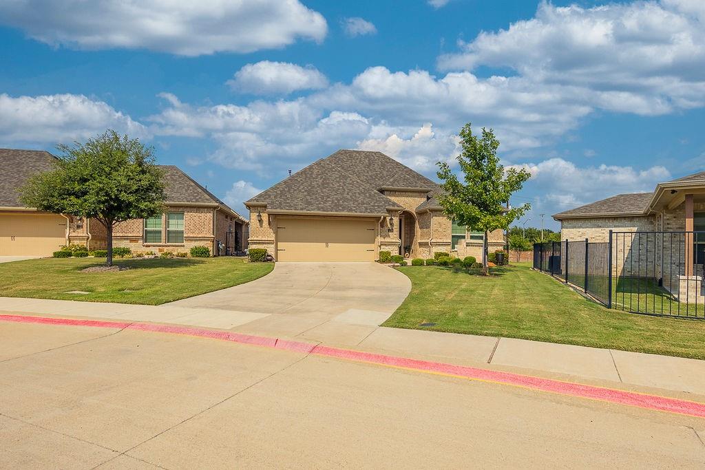 2123 Ladera Way, Unit 2123 Mansfield, TX 76063 - Photo 7 of 34 a yellow house with trees in front of it