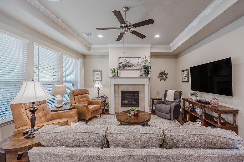 2123 Ladera Way, Unit 2123 Mansfield, TX 76063 - Photo 10 of 34 a living room with furniture and a flat screen tv with wooden floor