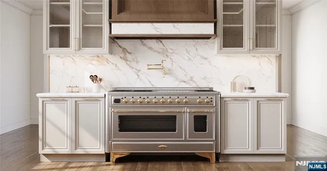 a stove top oven sitting inside of a kitchen