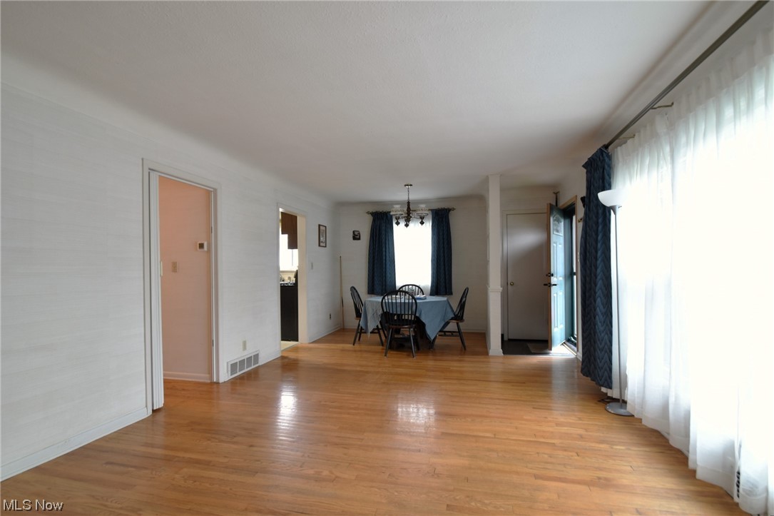 28740 Forest Road Willowick, OH 44095 - Photo 6 of 27 Unfurnished living room with a notable chandelier and light hardwood floors