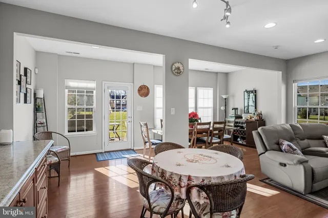 a living room with furniture a window and wooden floor