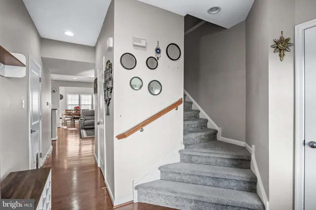a view of entryway and hall with wooden floor