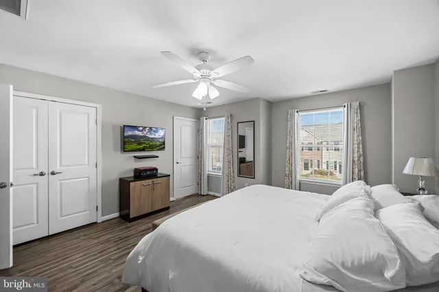 a spacious bedroom with a bed and a chandelier
