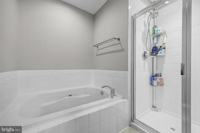 a white bath tub sitting next to a shower