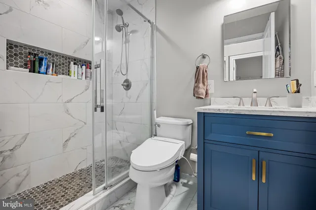 a bathroom with a toilet sink and shower