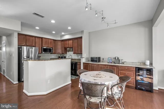 a kitchen with kitchen island a stove a table and chairs