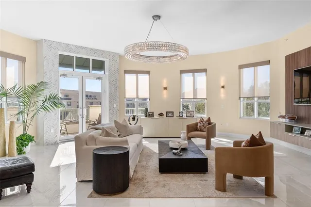 a living room with furniture a flat screen tv and a table