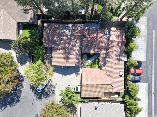 an aerial view of a house with a yard and potted plants