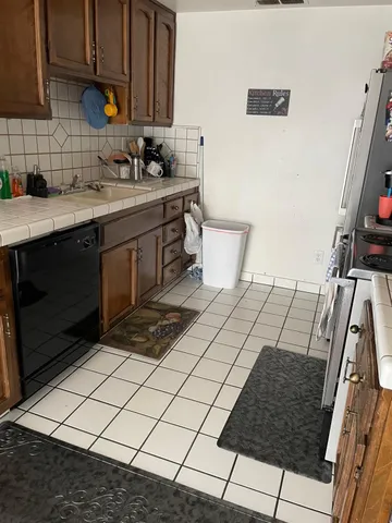 a kitchen with a sink and a stove top oven