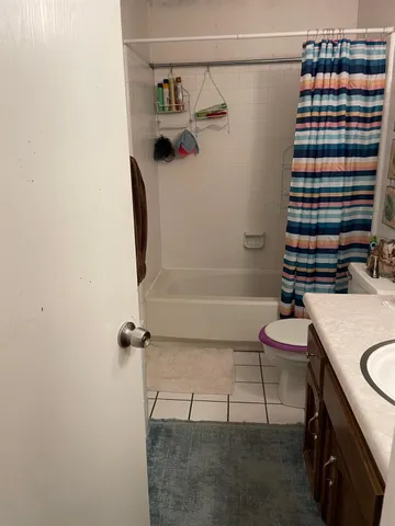 a bathroom with a sink and a shower curtain