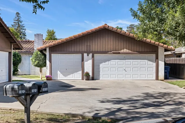 a backyard of a house with table and chairs