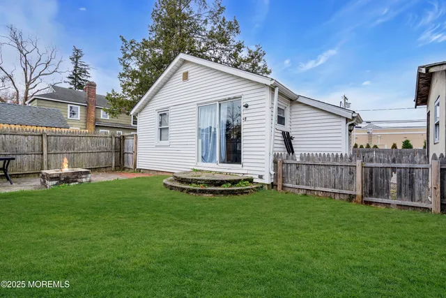 a view of a house with a yard and sitting area