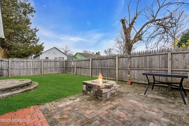 a view of a yard with furniture and wooden fence