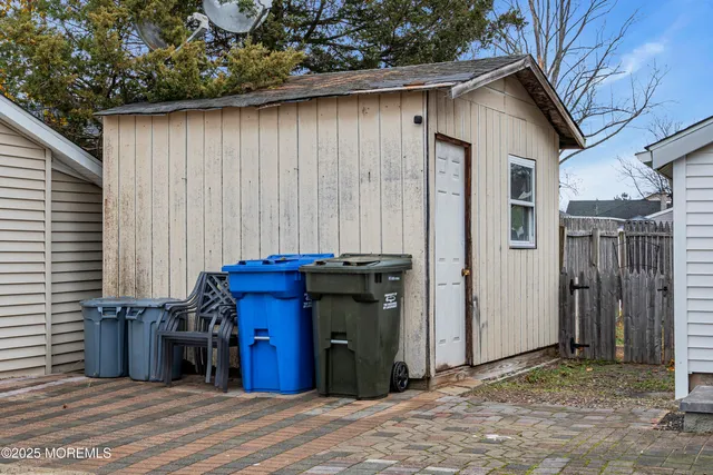 a view of a wooden door and a car parked in yard