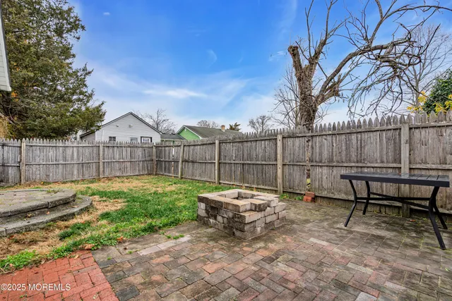 a view of a yard with furniture and wooden fence