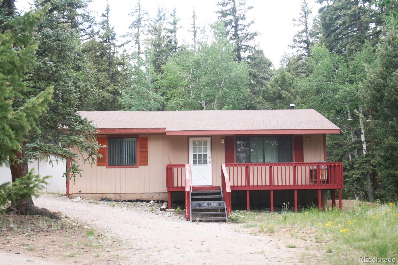 777 Singletree Road Hartsel, CO 80449 - Photo 1 of 31 a front view of a house with a yard and garage