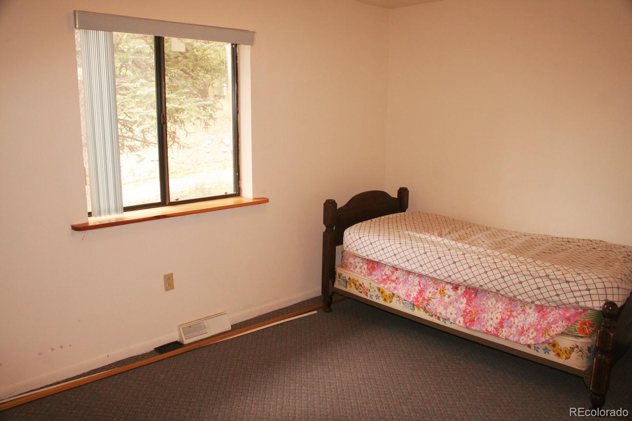 777 Singletree Road Hartsel, CO 80449 - Photo 17 of 31 a bedroom with a bed and a window