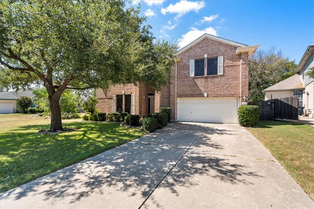 2126 Simbrah Drive Cedar Park, TX 78613 - Photo 1 of 1 a front view of a house with a yard and trees