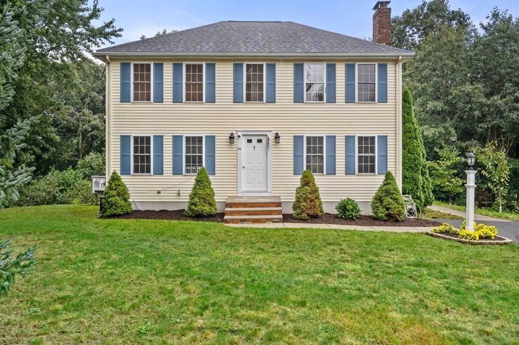 a front view of a house with a yard table and chairs