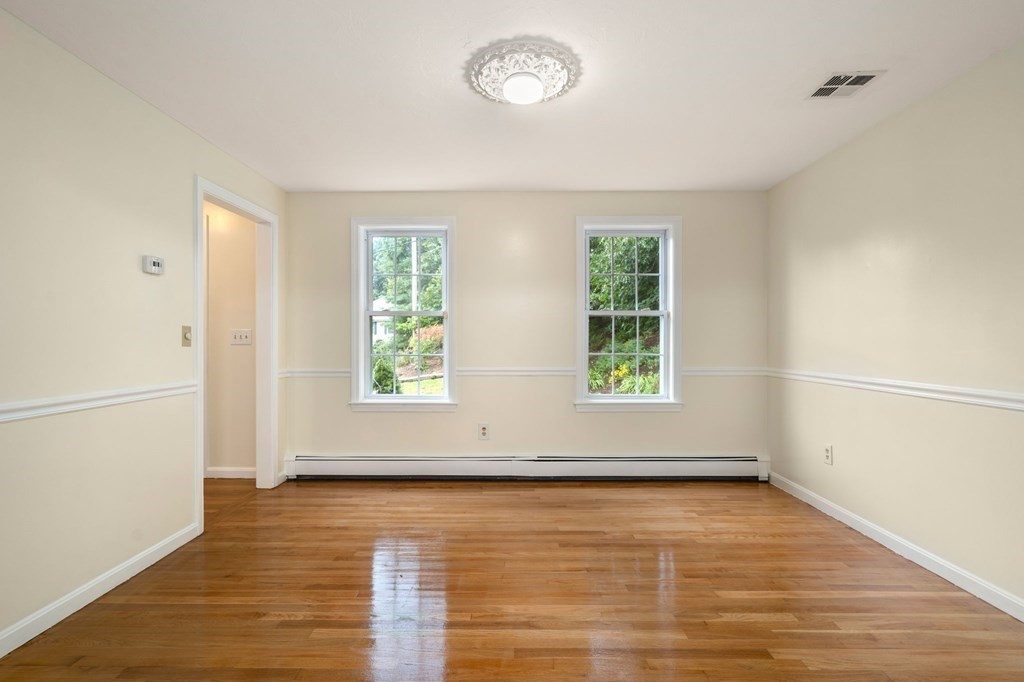 98 Allen Street Walpole, MA 02081 - Photo 15 of 37 an empty room with wooden floor and windows