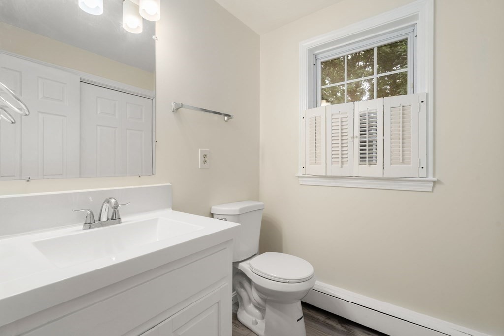 98 Allen Street Walpole, MA 02081 - Photo 16 of 37 a bathroom with a sink a toilet and a mirror