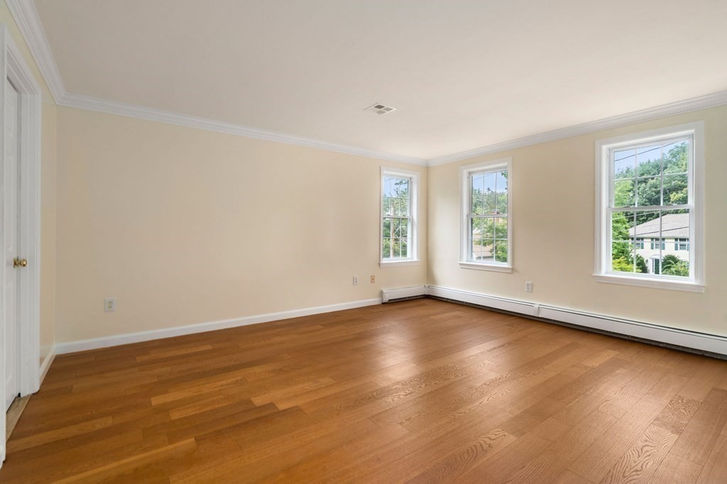98 Allen Street Walpole, MA 02081 - Photo 20 of 37 an empty room with wooden floor and windows