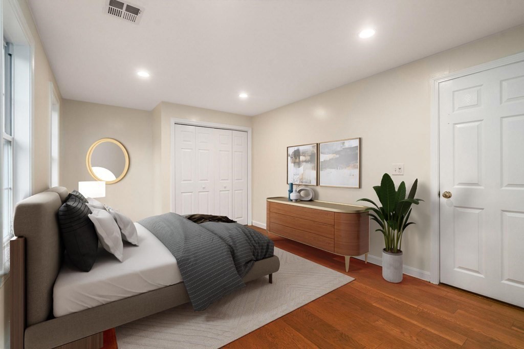 98 Allen Street Walpole, MA 02081 - Photo 22 of 37 a bed room with a bed and a potted plant